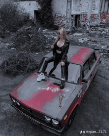 a woman is standing on top of a car that says " this baby is a red eye "