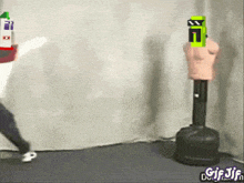 a gif of a person kicking a punching bag with a green e on it