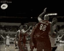 a group of basketball players are playing a game of basketball .