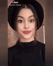 a girl wearing a black hat and a black sweater has likee written on her face