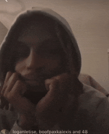 a person wearing a white hoodie with the words loganletise bootpaxkalexis and 48 on the bottom right
