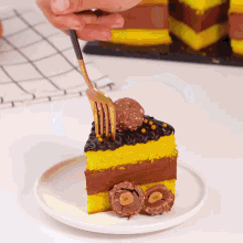a person is holding a fork over a slice of cake on a white plate