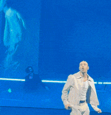 a man taking a picture of a group of people on stage