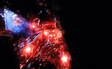 a person standing in a dark cave with red lights