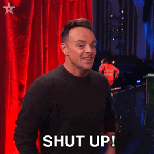 a man is making a funny face and saying shut up