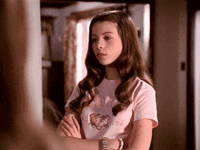 a young girl wearing a pink shirt that says santa pink