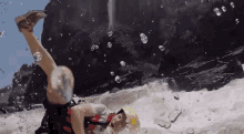 a person in a yellow helmet is upside down in a body of water