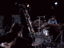 a group of people playing musical instruments on a stage