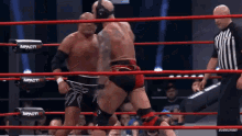 two men are wrestling in a ring that says impact on the corner