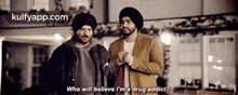 two men are standing next to each other and talking to each other .