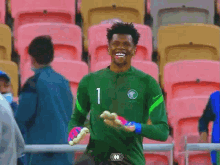 a soccer player in a green jersey with the number 1 on it