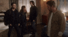 a group of people are standing in a room with a sign on the wall that says space