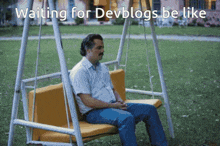 a man sits on a swing with the words " waiting for devblogs be like "