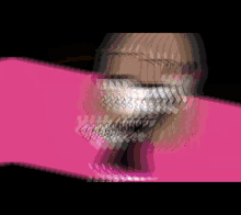 a blurry picture of a girl with glasses on a pink background .