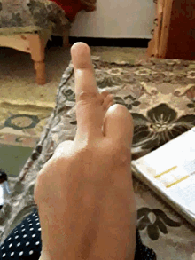 a close up of a person 's finger pointing to the right