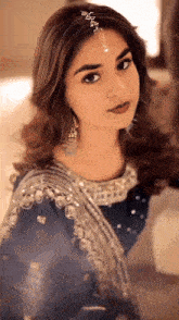 a close up of a woman wearing a headpiece