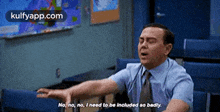 a man in a suit and tie is sitting in a classroom with his arms outstretched .