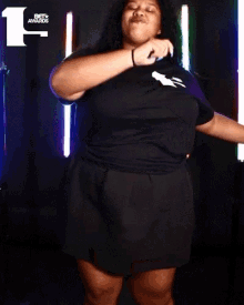 a woman is dancing in front of a bet awards sign