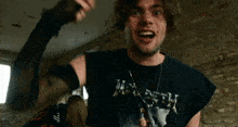 a man is wearing a black shirt that says megadeth