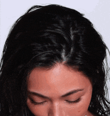 a close up of a woman 's face and hair with her eyes closed