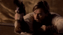 a man is holding a gun that is shooting a red light