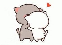 two cats are standing next to each other and hugging .
