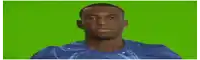 a man in a blue shirt is smiling in front of a green background .