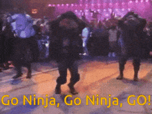 a group of people are dancing with the words go ninja go ninja go in the background