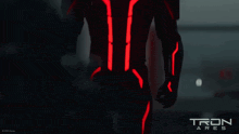 a tron ares poster with a man in a black suit