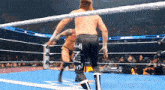 two men are wrestling in a ring with one wearing a pair of shorts that say ami on them