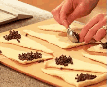 Dropping Chocolate Chips GIF - Baking Treats Nuts GIFs