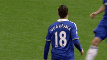 a soccer player with the number 18 on his jersey