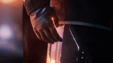 a close up of a person 's hand wearing gloves