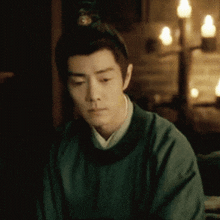 a man with a crown on his head looks down at something