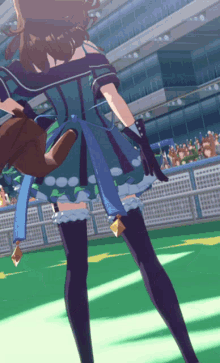 a girl in a blue dress and black stockings is standing on a green field
