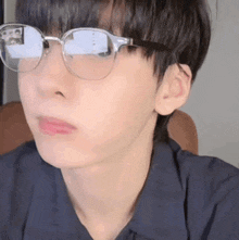 a close up of a person wearing glasses making a face .