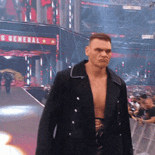 a man in a black jacket stands in front of a sign that says general