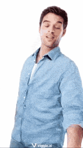 a man in a blue shirt is standing with his eyes closed and a viggle.ai logo in the corner