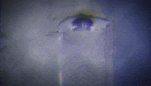 a close up of a woman 's eye with a tear running down it