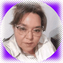 a woman wearing glasses and a white jacket is looking at the camera .