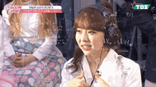 a girl wearing headphones is sitting in front of a chalkboard with math equations on it