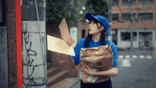 a woman in a blue uniform holds a bag that says dhl