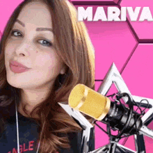a woman is standing in front of a microphone with mariva written on the top