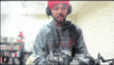 a blurry picture of a man wearing headphones and a hat