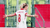 a female soccer player wearing a number 8 jersey