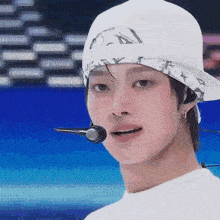 a close up of a person wearing a hat and a bandana .