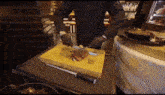 a chef is cutting a piece of meat on a cutting board