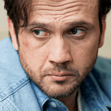 a close up of a man 's face with his eyes closed