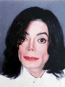 a close up of a person 's face with a white shirt on