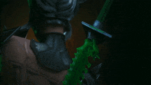 a statue of a man with a green sword behind his back